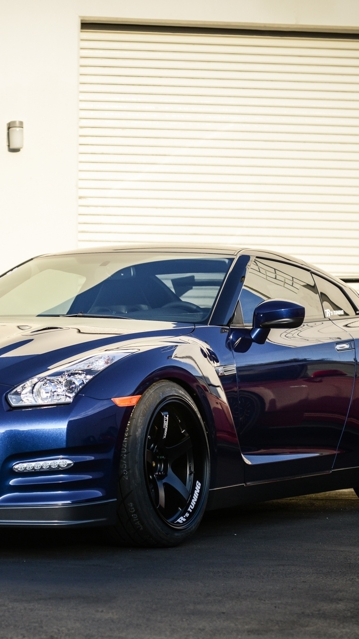 Blue Bmw m 3 Coupe Parked Near White Roll up Door. Wallpaper in 720x1280 Resolution