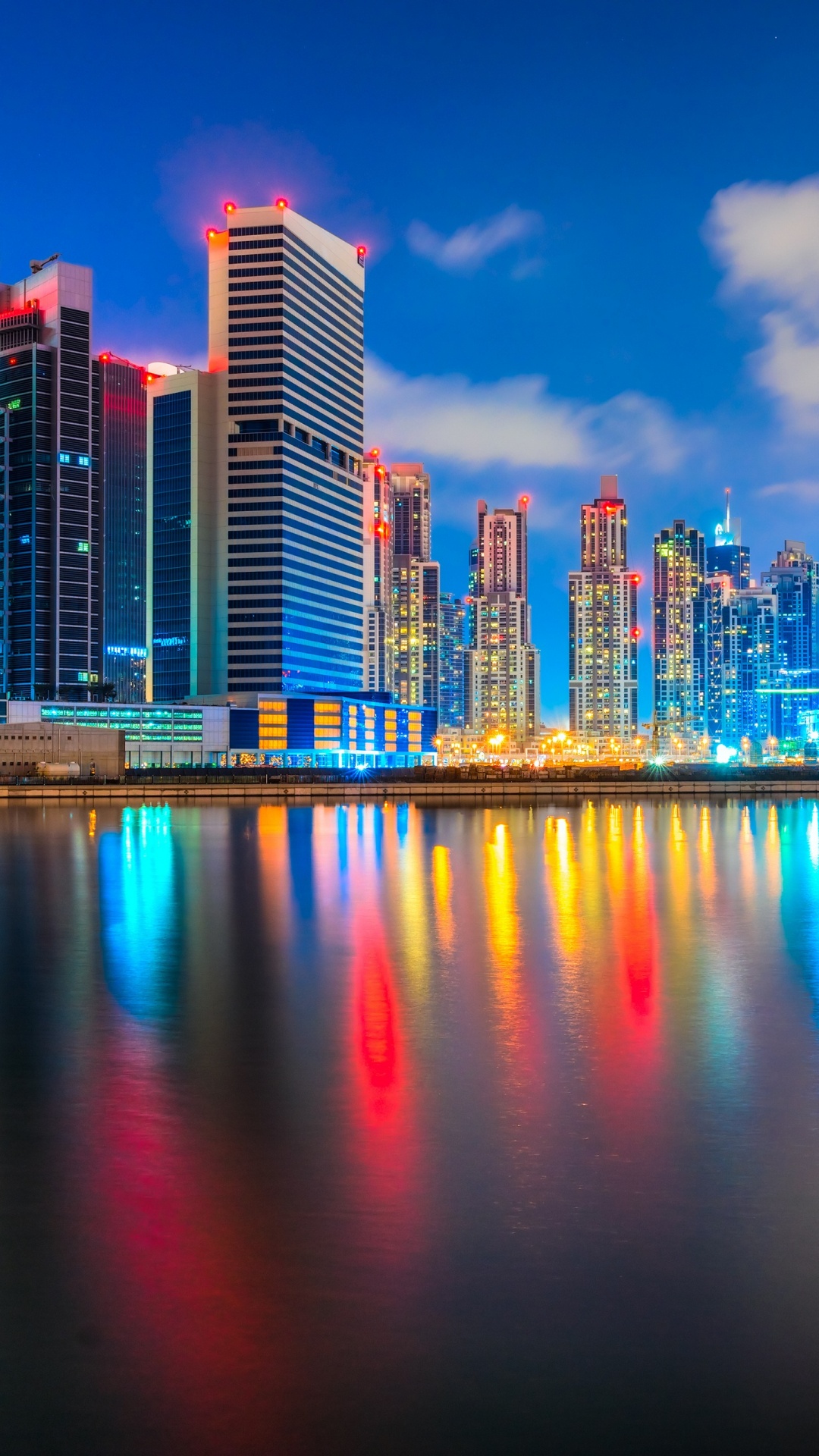 City Skyline Across Body of Water During Night Time. Wallpaper in 1080x1920 Resolution