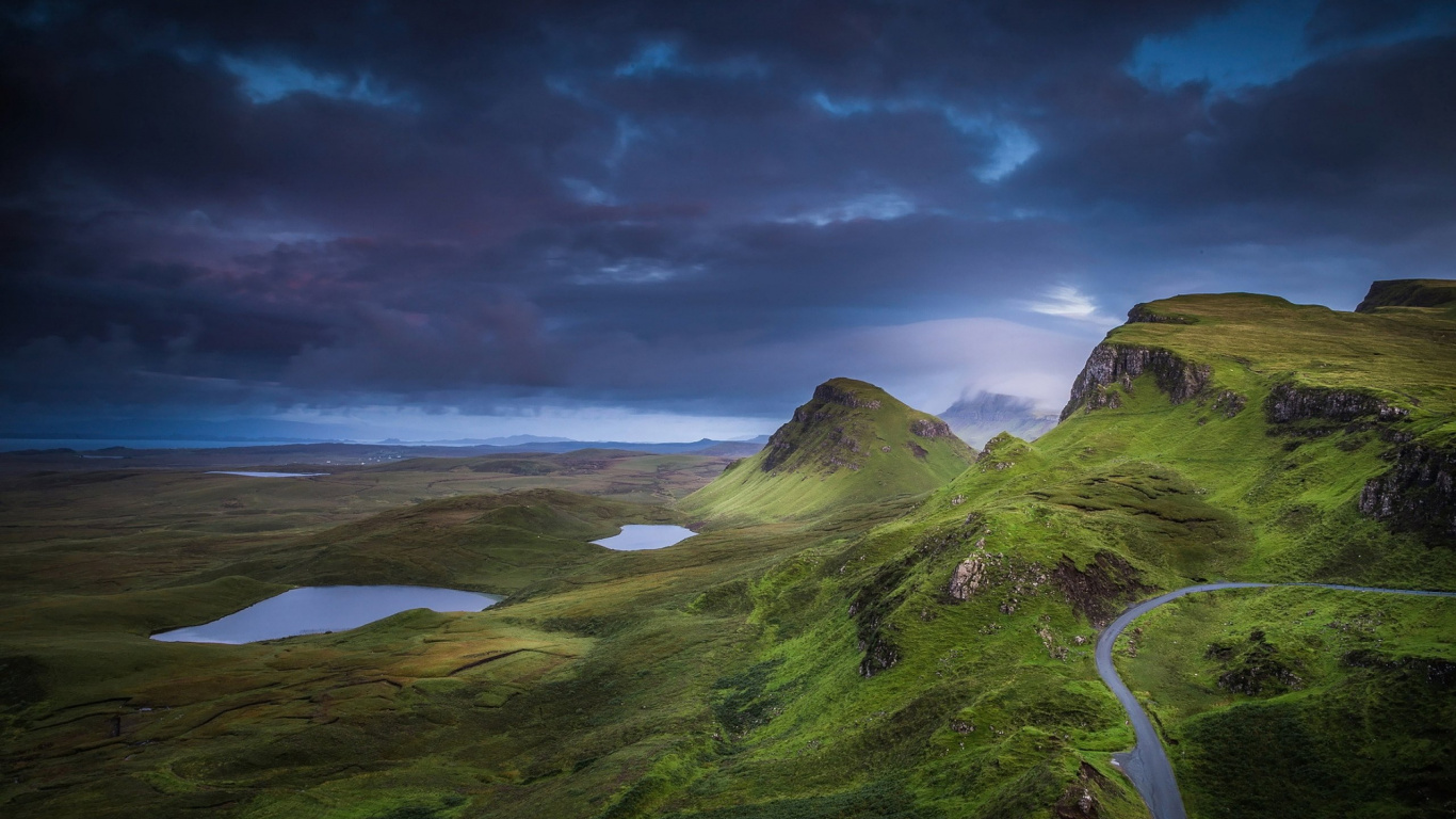 Green Grass Field Near Body of Water Under Cloudy Sky During Daytime. Wallpaper in 1366x768 Resolution