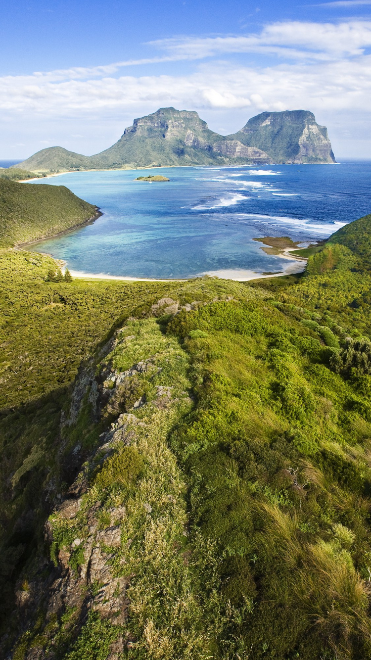 Green Mountain Beside Body of Water During Daytime. Wallpaper in 750x1334 Resolution