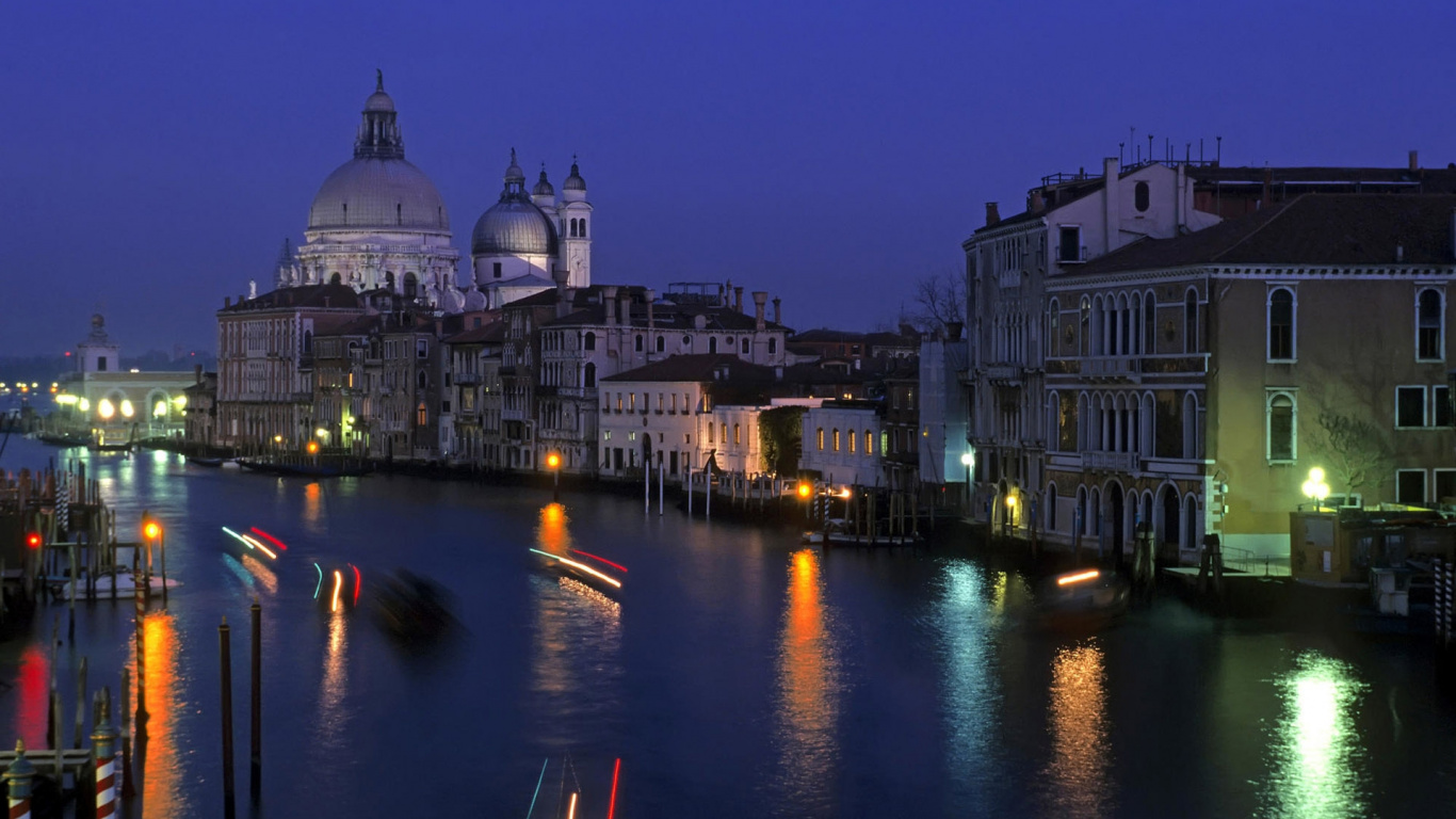 White and Brown Concrete Building Near Body of Water During Night Time. Wallpaper in 1366x768 Resolution