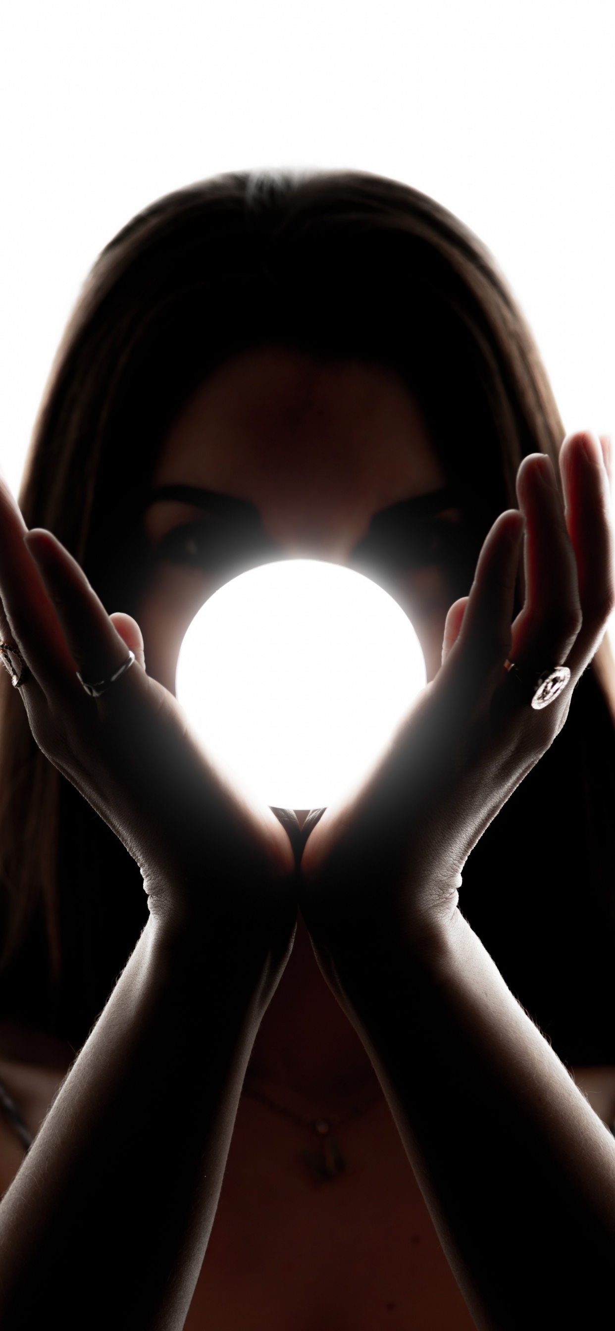 Woman Covering Her Face With Her Hands. Wallpaper in 1242x2688 Resolution