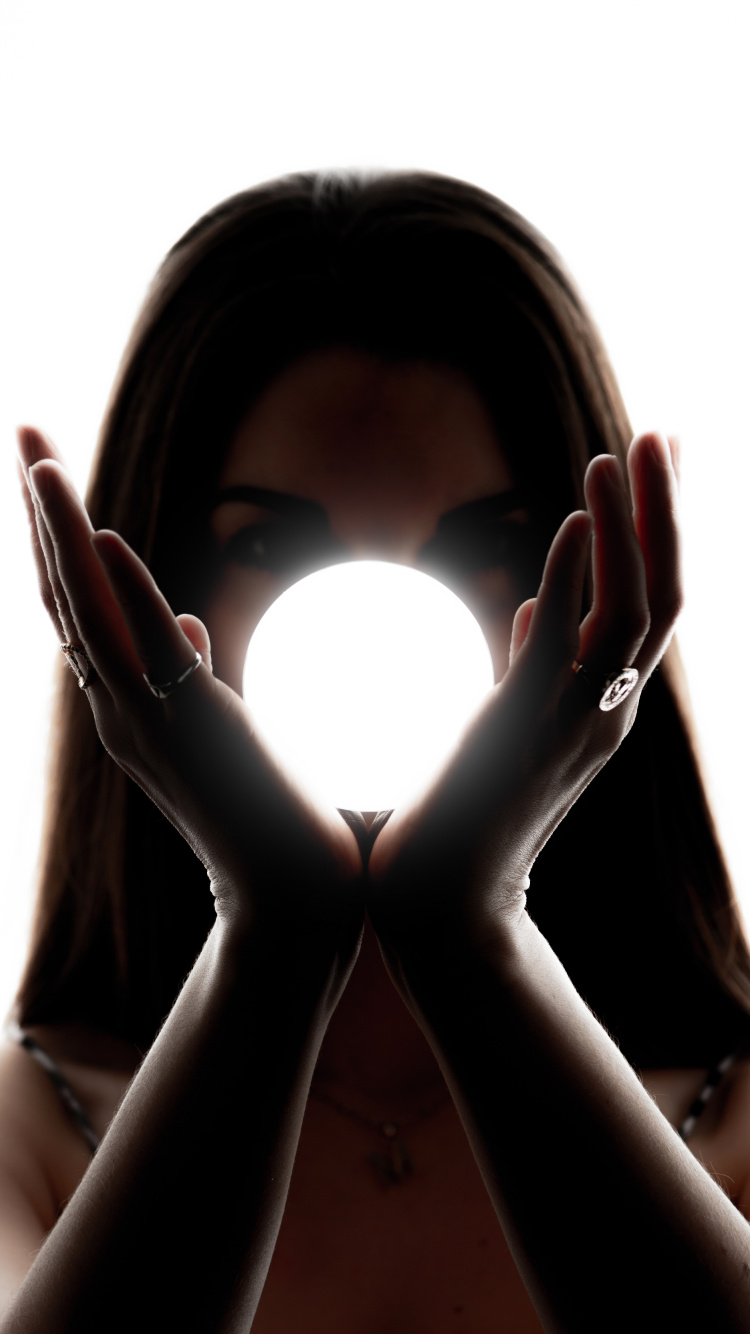 Woman Covering Her Face With Her Hands. Wallpaper in 750x1334 Resolution