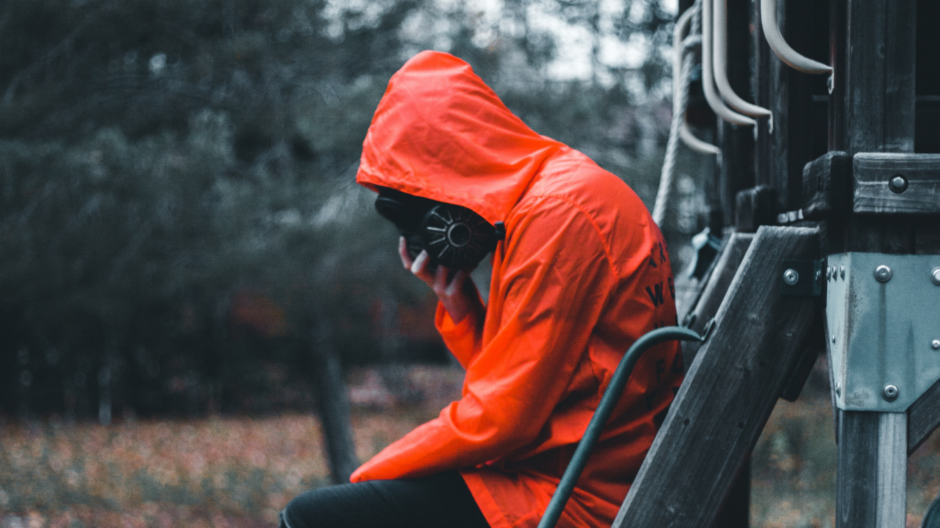 Man in Orange Hoodie and Black Pants Sitting on Brown Wooden Ladder. Wallpaper in 1366x768 Resolution