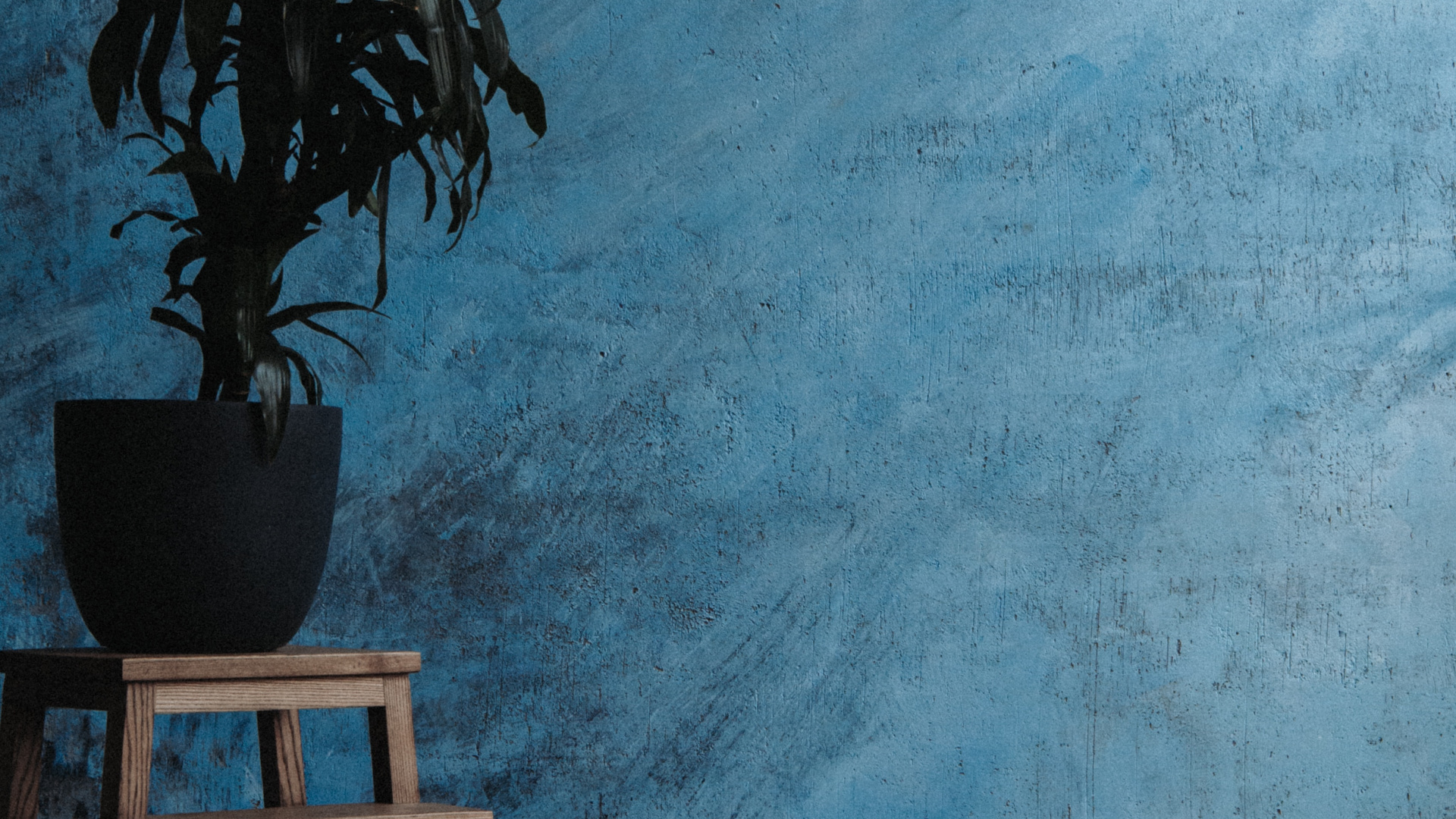 Brown Wooden Table Beside Blue Painted Wall. Wallpaper in 1920x1080 Resolution