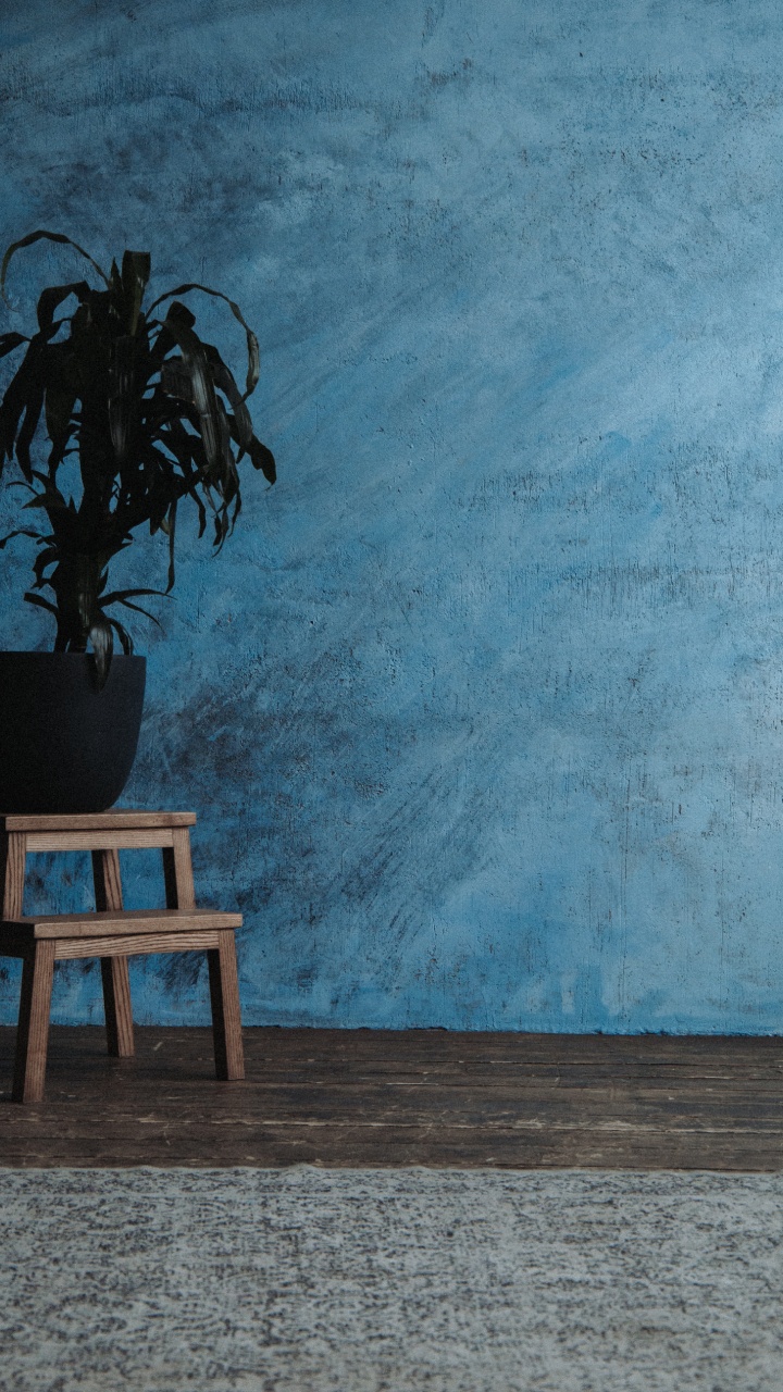 Brown Wooden Table Beside Blue Painted Wall. Wallpaper in 720x1280 Resolution
