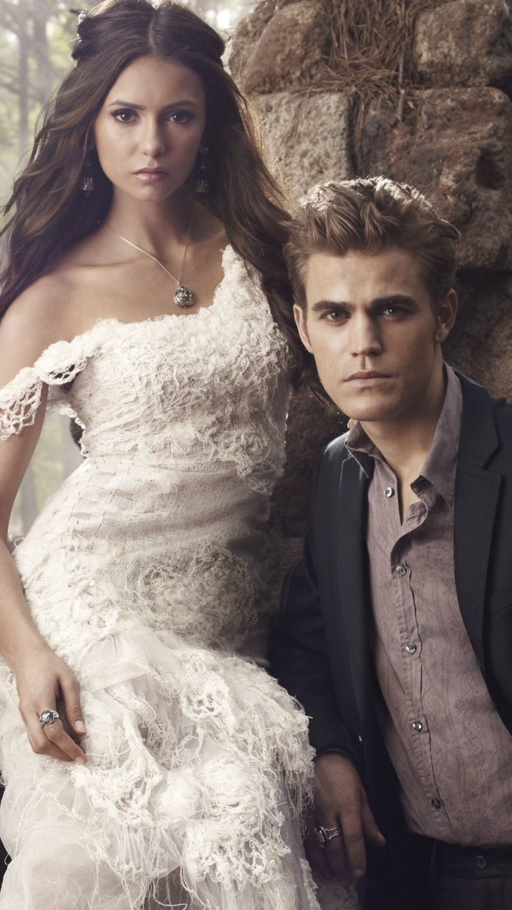 Woman in White Wedding Gown Beside Man in Black Suit. Wallpaper in 720x1280 Resolution