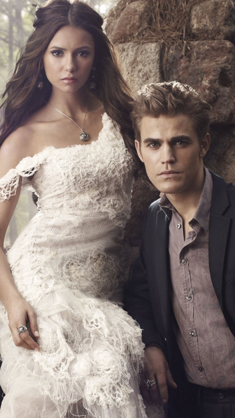 Woman in White Wedding Gown Beside Man in Black Suit. Wallpaper in 750x1334 Resolution