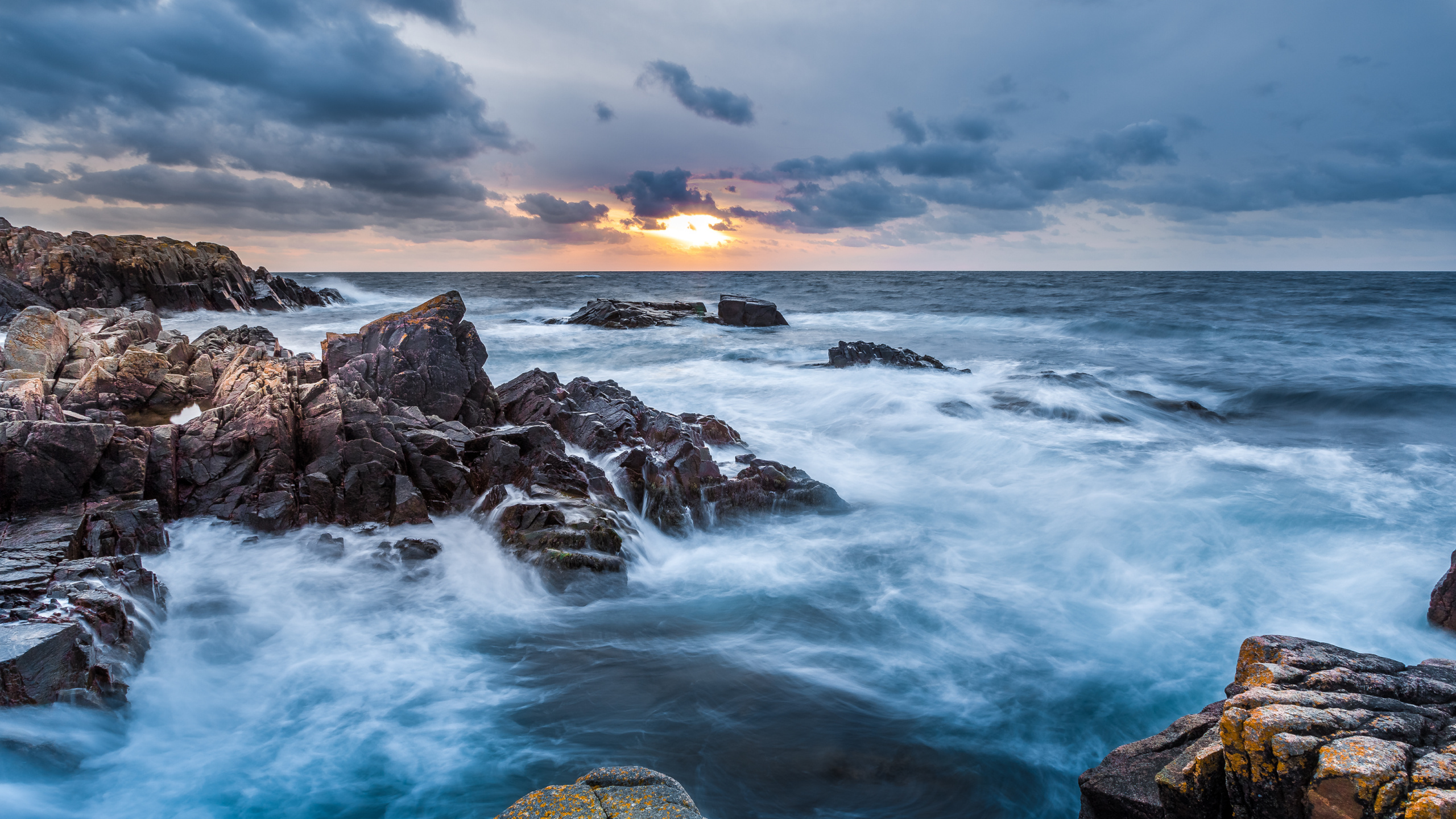Rocky Shore With Ocean Waves Under Cloudy Sky During Daytime. Wallpaper in 2560x1440 Resolution