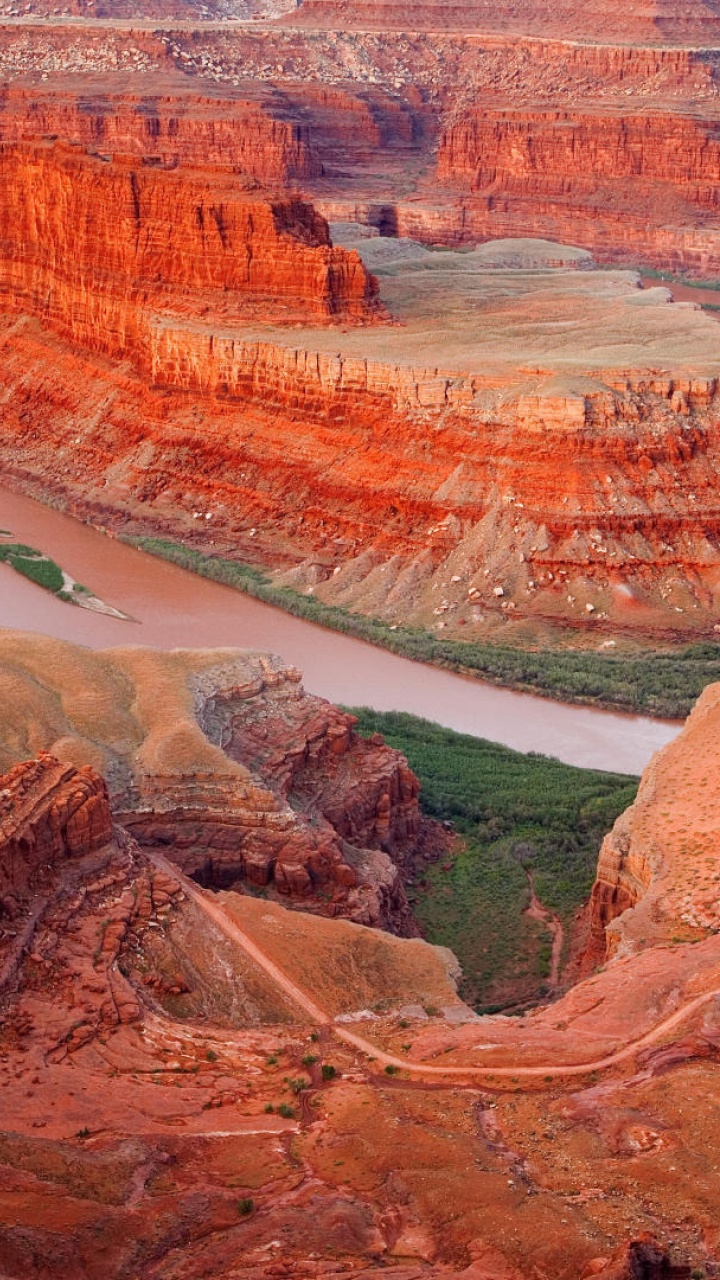 Aerial View of Brown and Green Mountains and Body of Water. Wallpaper in 720x1280 Resolution