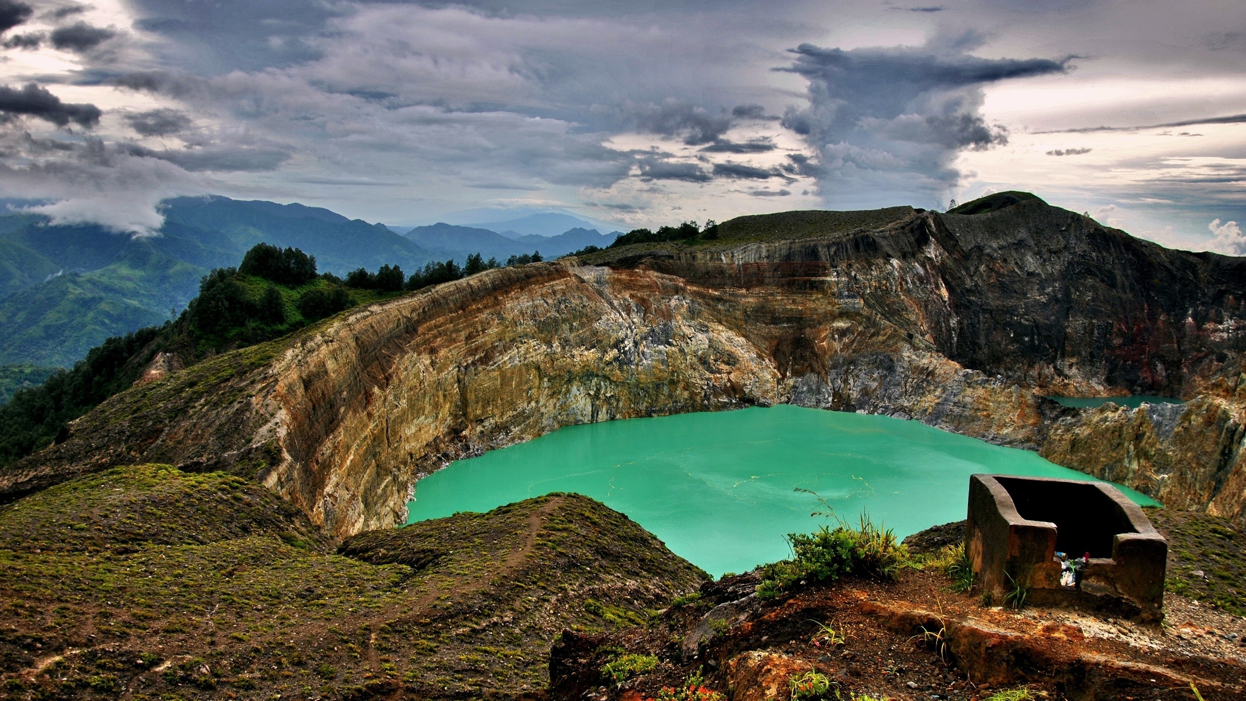 Blue Lake in The Middle of Green and Brown Mountains Under Blue Sky and White Clouds. Wallpaper in 2560x1440 Resolution