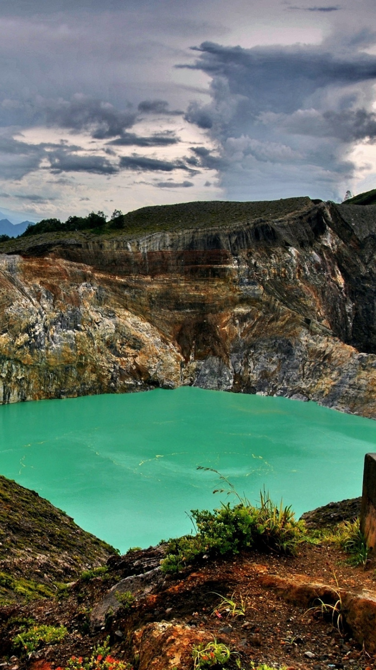 Blue Lake in The Middle of Green and Brown Mountains Under Blue Sky and White Clouds. Wallpaper in 750x1334 Resolution