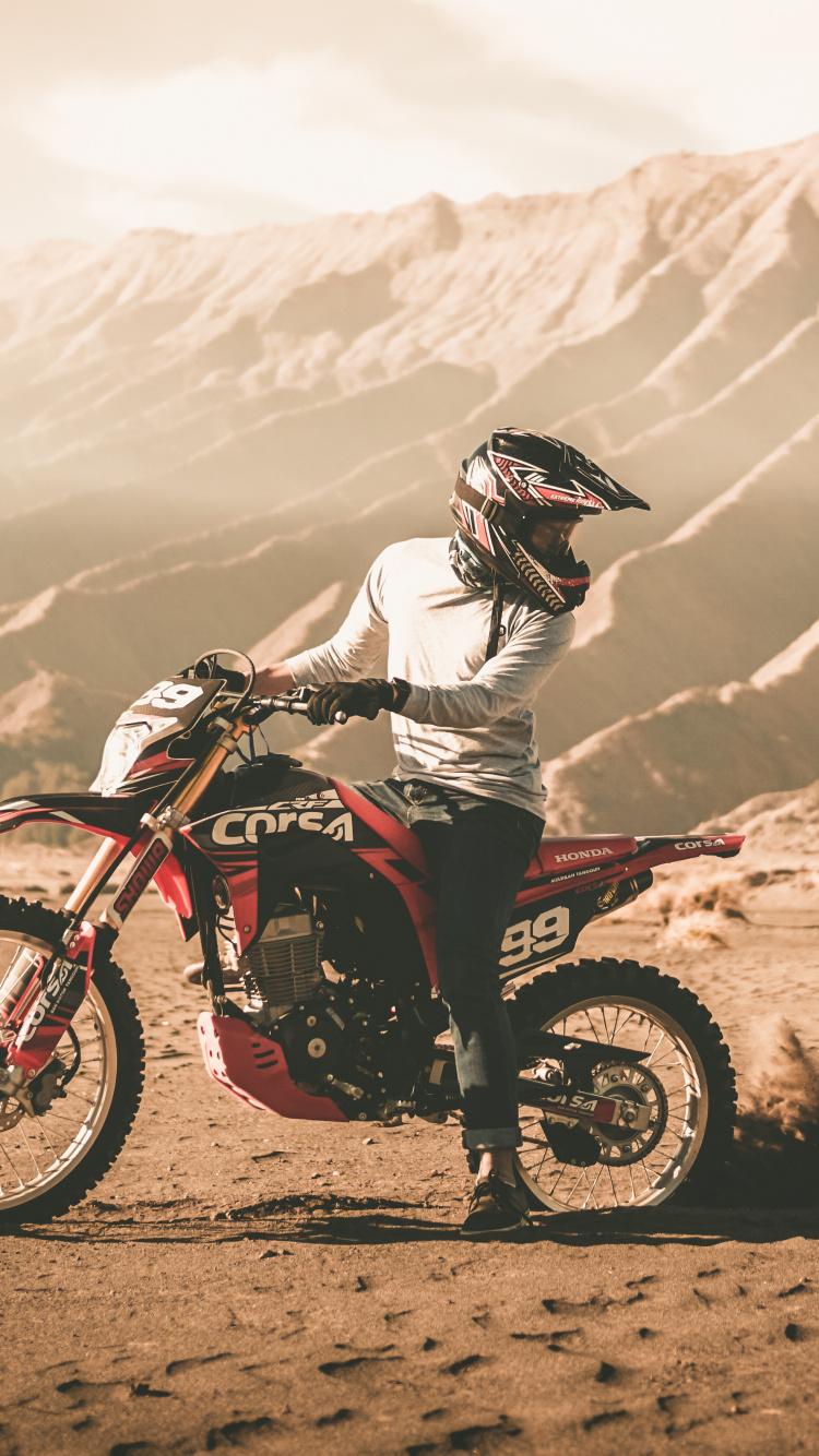 Man Riding Motocross Dirt Bike on Dirt Road During Daytime. Wallpaper in 750x1334 Resolution