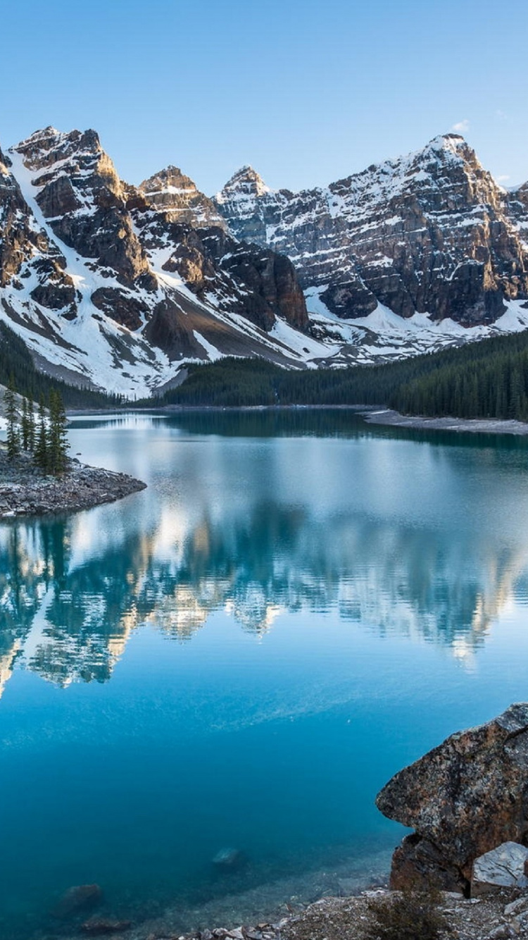 Lake Surrounded by Trees and Mountains During Daytime. Wallpaper in 750x1334 Resolution