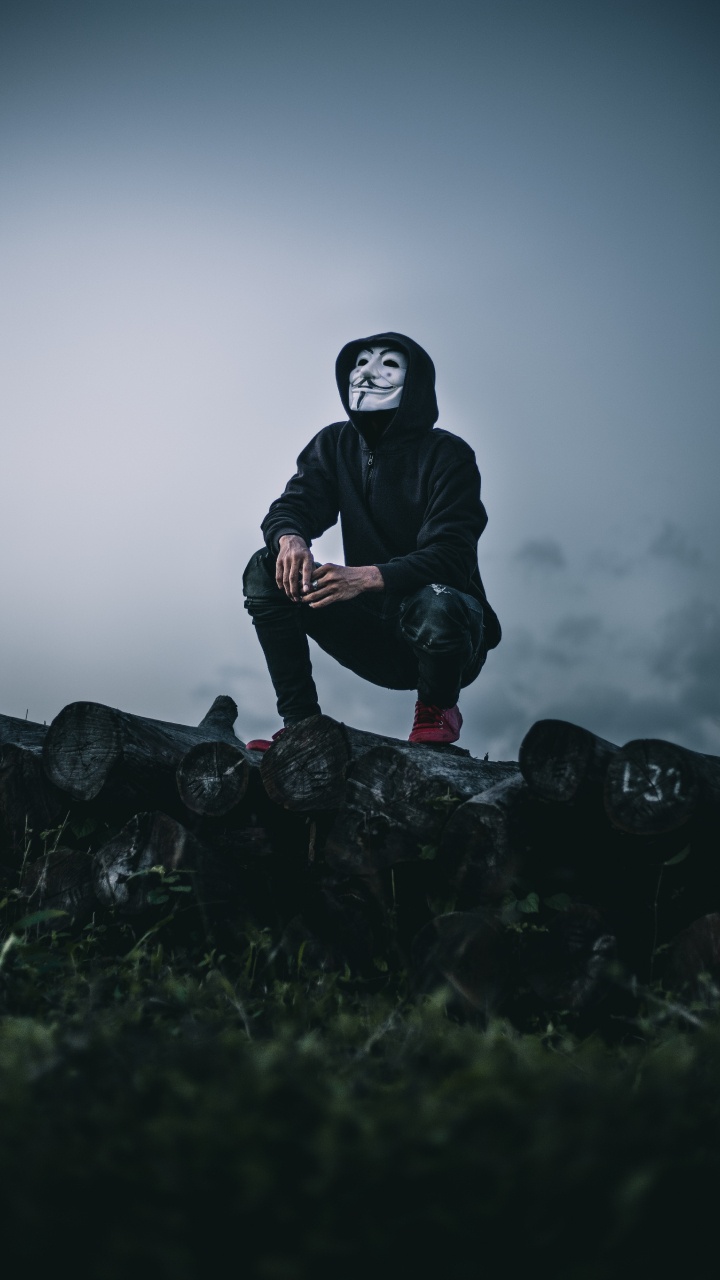 Man in Black Jacket Sitting on Rock. Wallpaper in 720x1280 Resolution