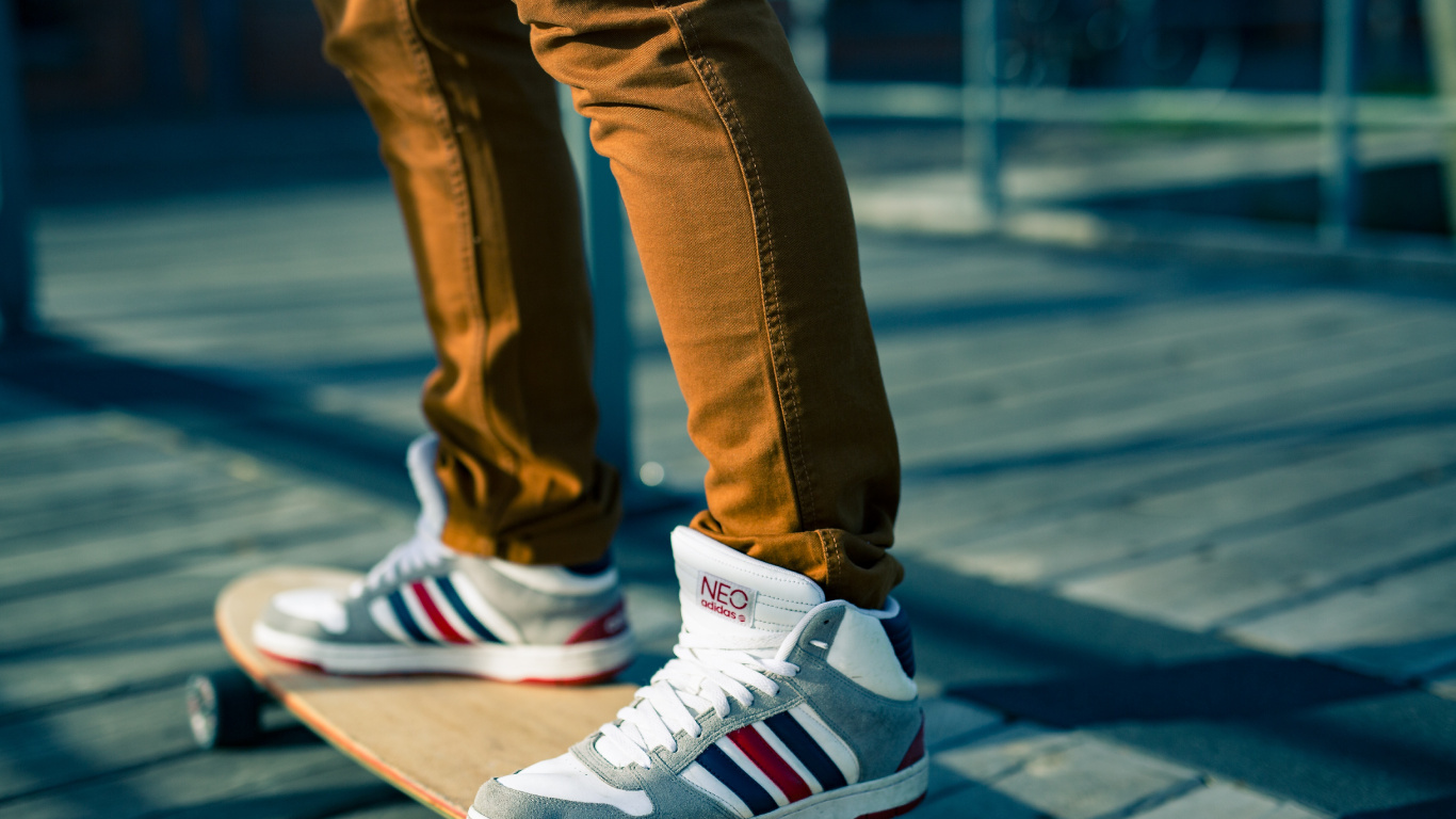 Person in Blue Denim Jeans Wearing White Red and Black Nike Sneakers. Wallpaper in 1366x768 Resolution