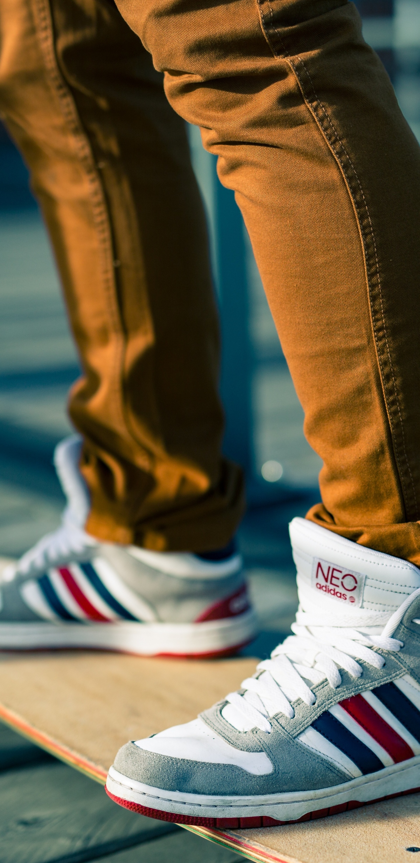 Person in Blue Denim Jeans Wearing White Red and Black Nike Sneakers. Wallpaper in 1440x2960 Resolution