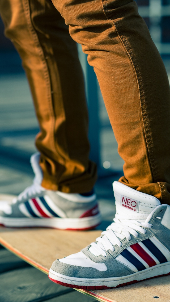 Person in Blue Denim Jeans Wearing White Red and Black Nike Sneakers. Wallpaper in 720x1280 Resolution