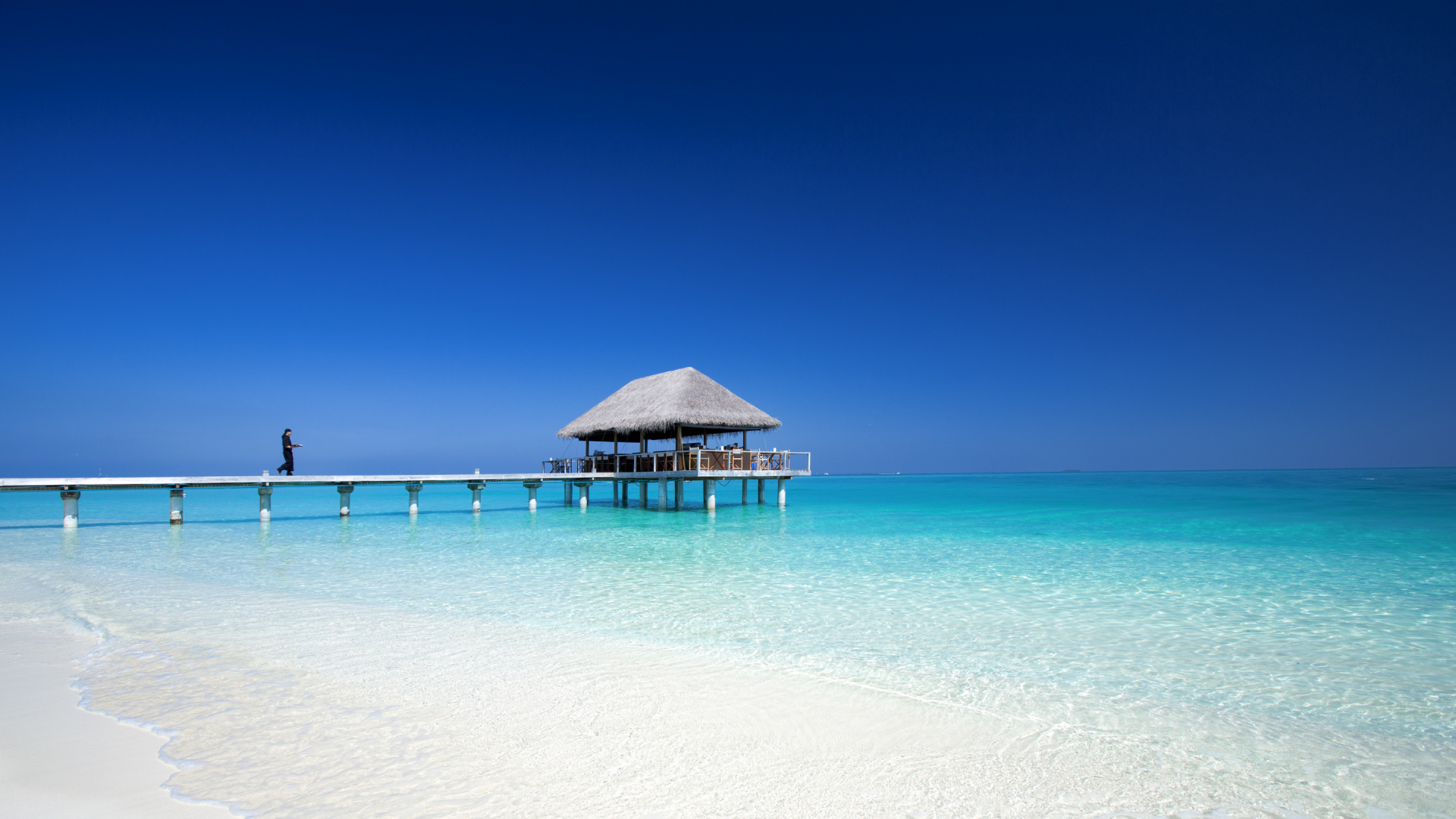 Brown Wooden Beach House on White Sand Beach During Daytime. Wallpaper in 1920x1080 Resolution