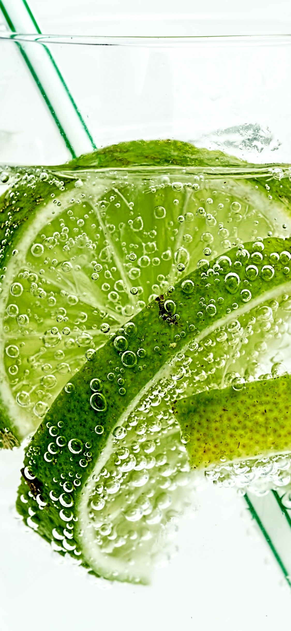 Clear Drinking Glass With Water and Sliced Lemon. Wallpaper in 1125x2436 Resolution