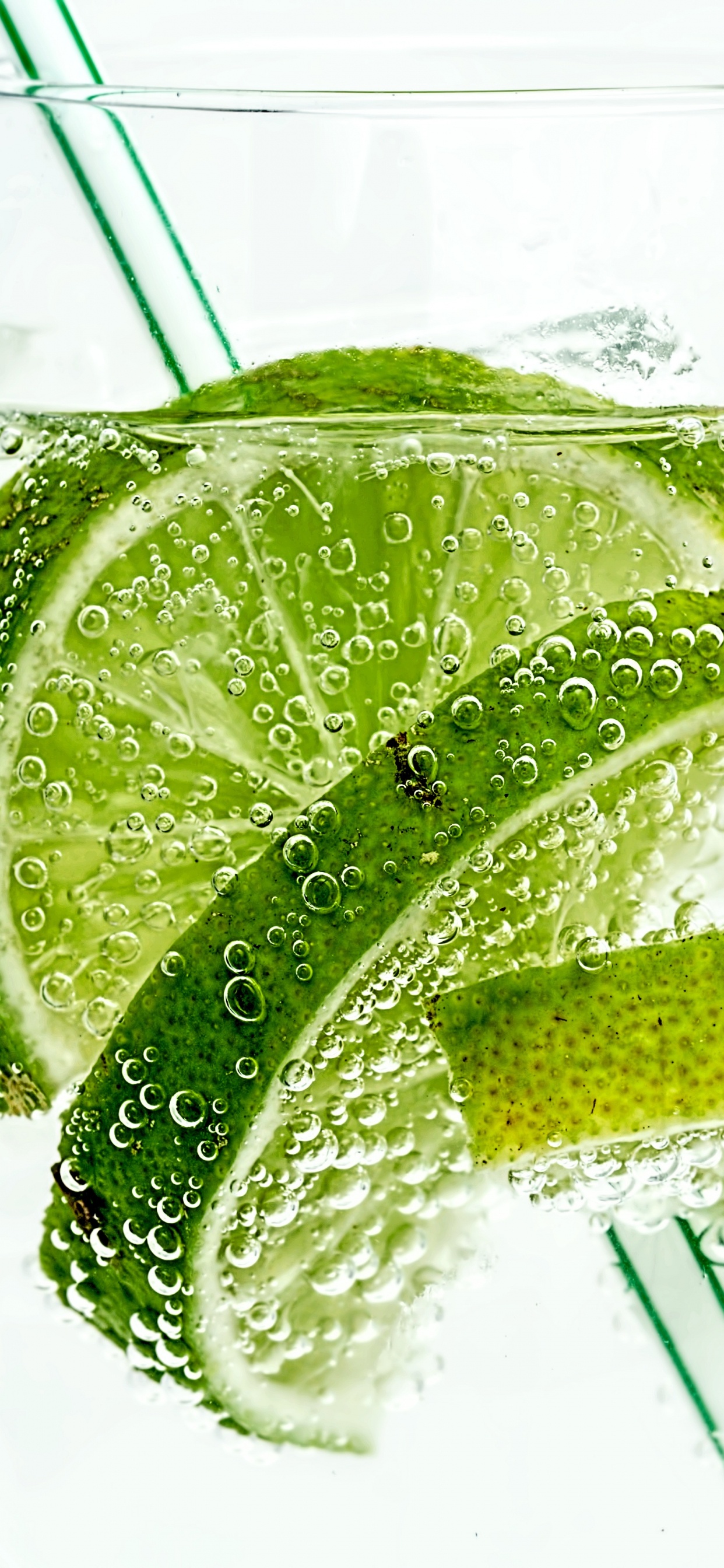 Clear Drinking Glass With Water and Sliced Lemon. Wallpaper in 1242x2688 Resolution