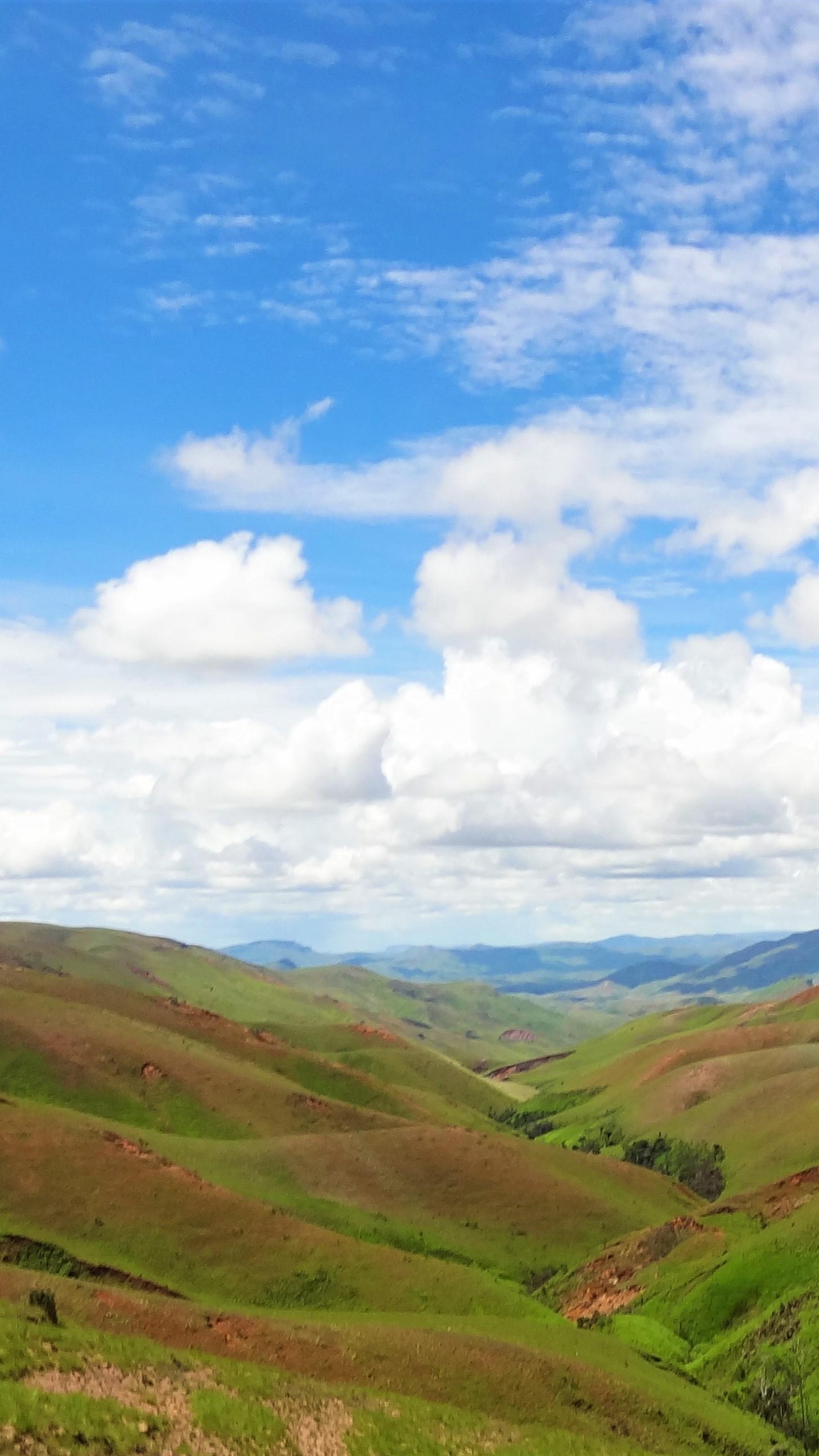 Green Mountains Under Blue Sky and White Clouds During Daytime. Wallpaper in 1440x2560 Resolution