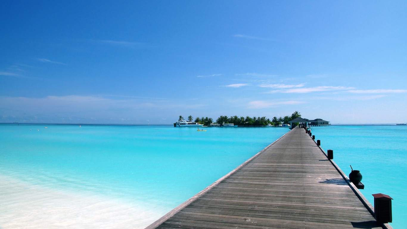 Brown Wooden Dock on Blue Sea Under Blue Sky During Daytime. Wallpaper in 1366x768 Resolution