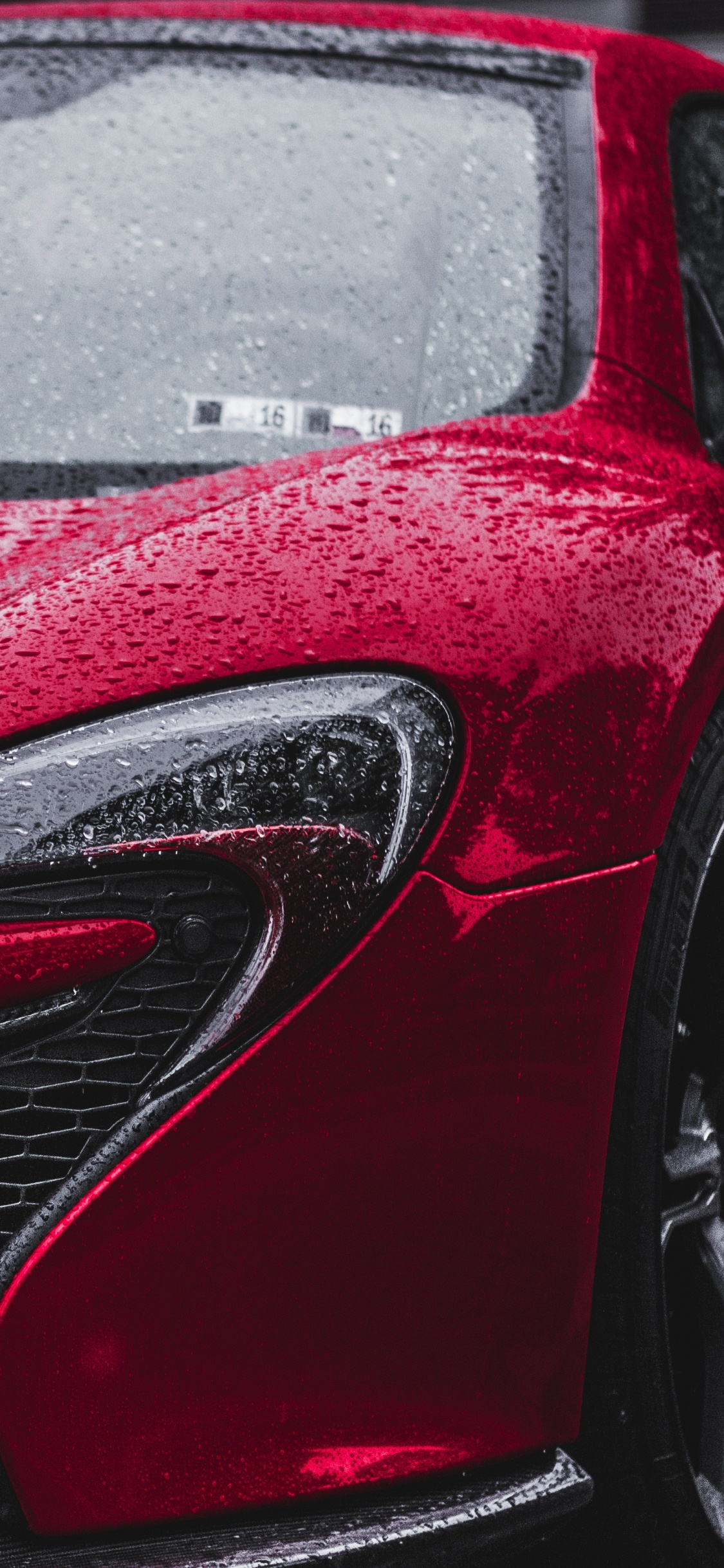 Red Car on Gray Asphalt Road During Daytime. Wallpaper in 1125x2436 Resolution