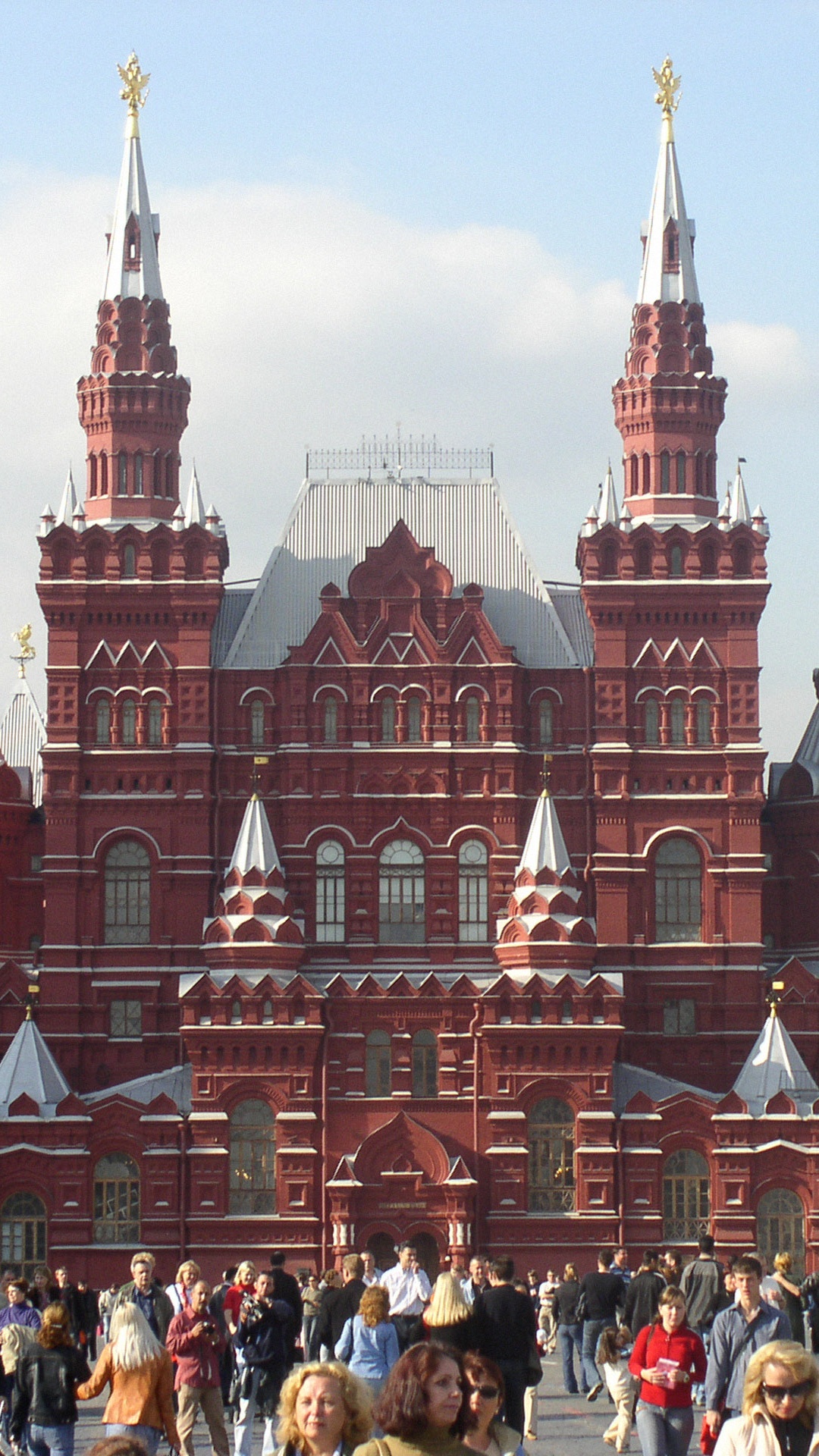 People Walking on Street Near Red and White Concrete Building During Daytime. Wallpaper in 1080x1920 Resolution