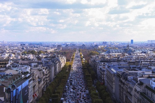 Image city with high rise buildings under white clouds during daytime