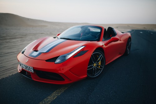 Image red ferrari sports car on black asphalt road during daytime