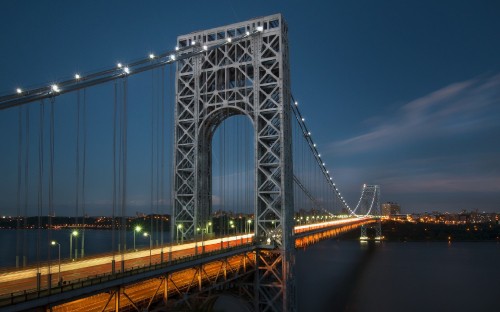 Image gray bridge over body of water during night time