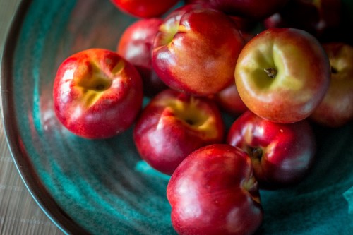 Image red apples on green ceramic plate