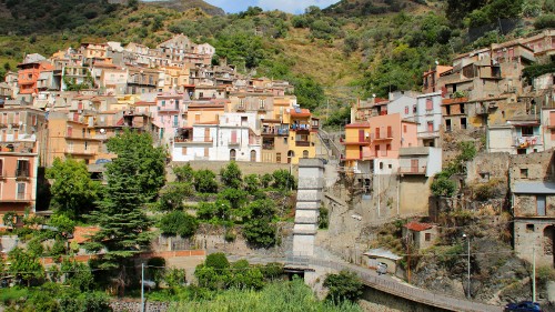 Image white and brown concrete buildings near green trees during daytime