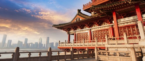 Image red and white temple near body of water during daytime