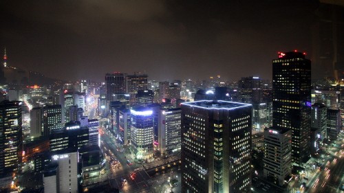 Image city with high rise buildings during night time