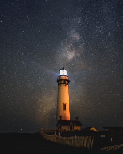 Image white and black light house under starry night