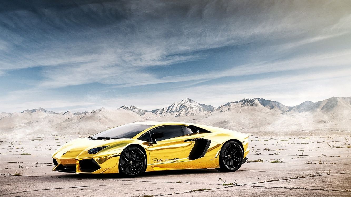Yellow Lamborghini Aventador on Snow Covered Field During Daytime. Wallpaper in 2560x1440 Resolution