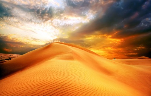 Image brown sand under white clouds during daytime