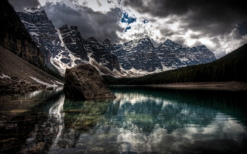 Image lake near mountain under cloudy sky during daytime