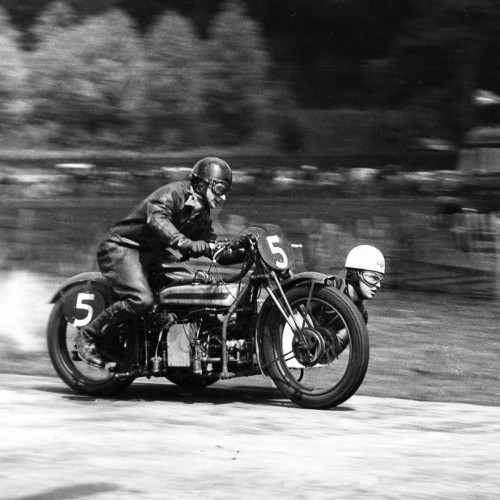 Image grayscale photo of man riding motorcycle