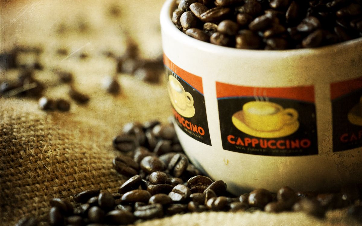 white ceramic mug with coffee beans