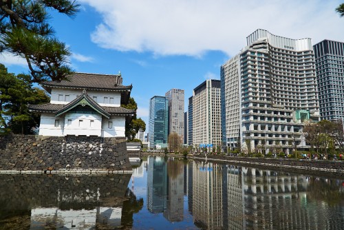 Image white concrete building near body of water during daytime