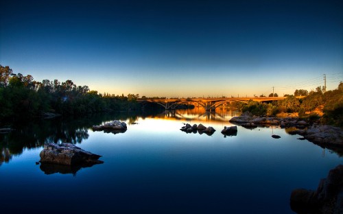 Image body of water near trees during sunset