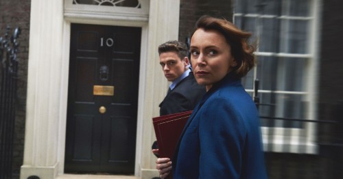 Image man in blue sweater standing beside woman in black coat