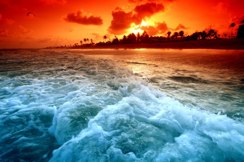 Image ocean waves crashing on shore during sunset