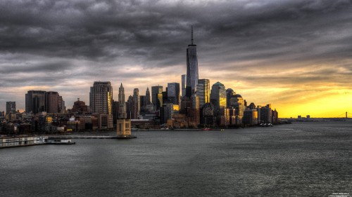 Image city skyline across body of water during daytime