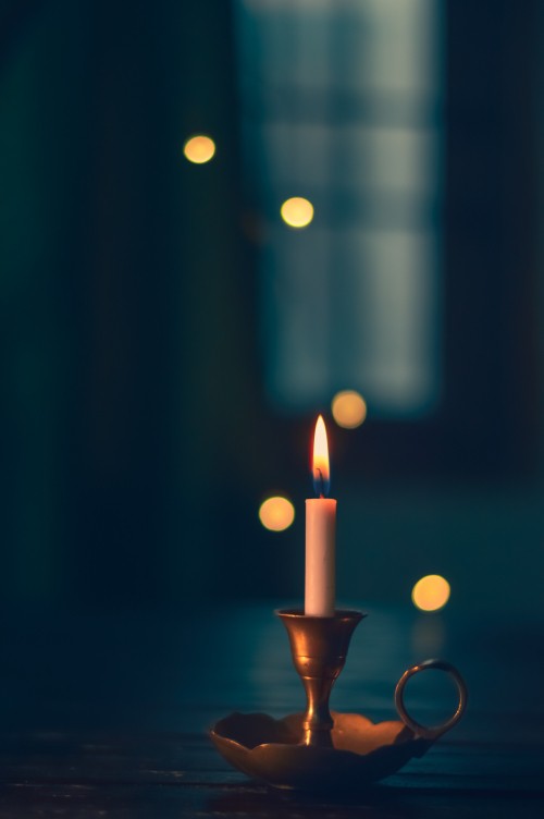 Image lighted candle in black holder