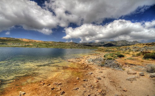 Image body of water under cloudy sky during daytime