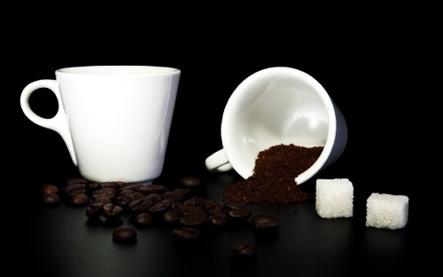 Image white ceramic mug beside brown coffee beans